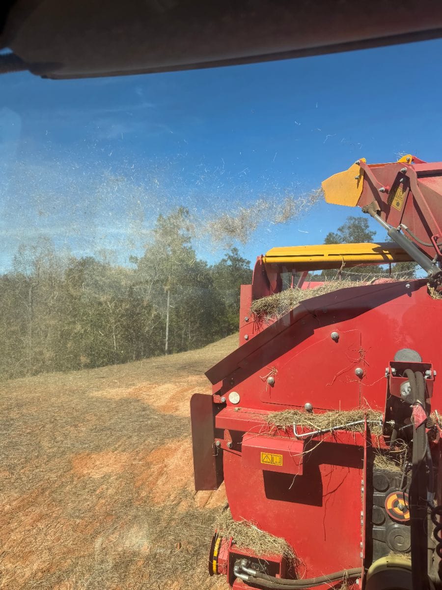 Straw blower spreading straw over a seeded slope