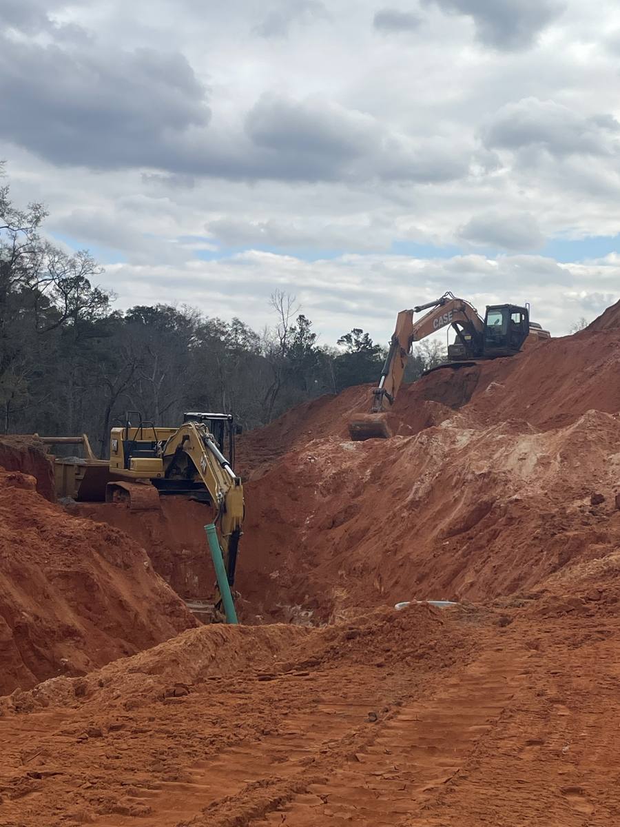 Deep trench with two excavators working the cut